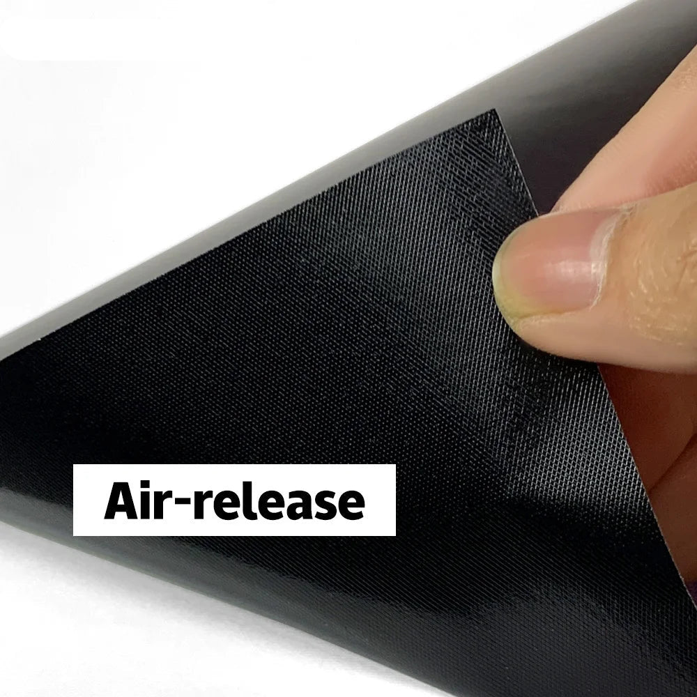 Black air-release film being peeled back with a hand, branded 'CWRAPPING'.