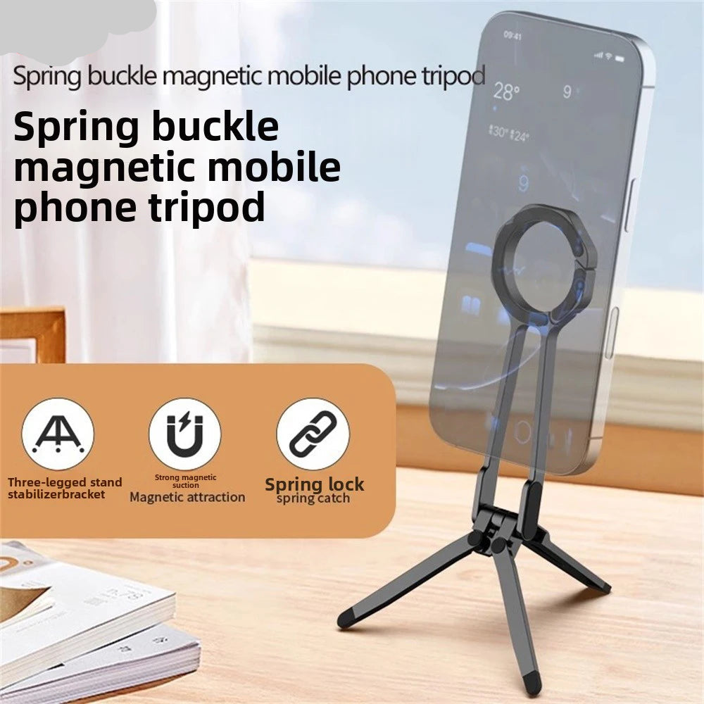 Spring buckle magnetic mobile phone tripod with smartphone on a wooden surface