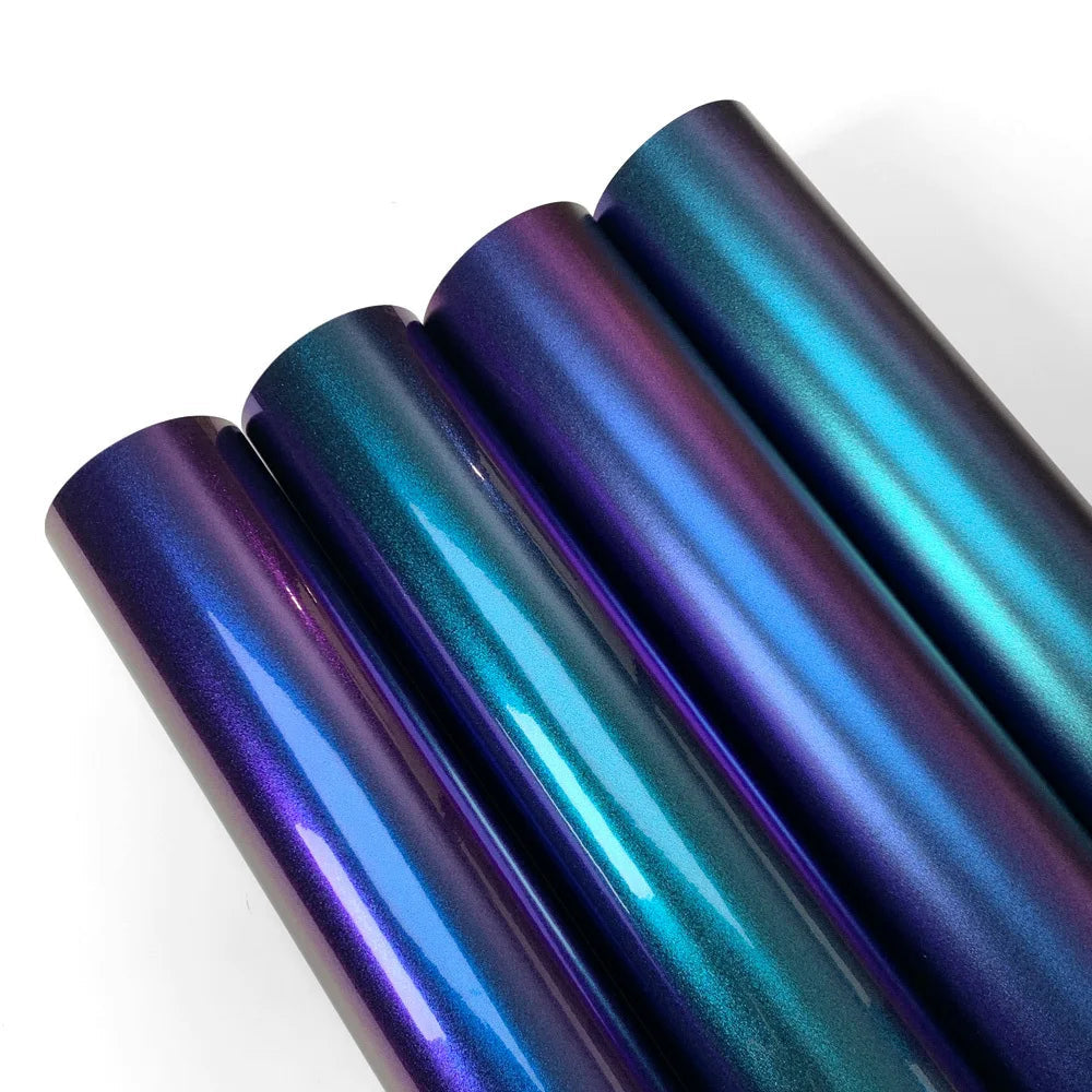 Four rolls of metallic blue and purple vinyl wrap on a white background with 'CWRAPPING' branding.